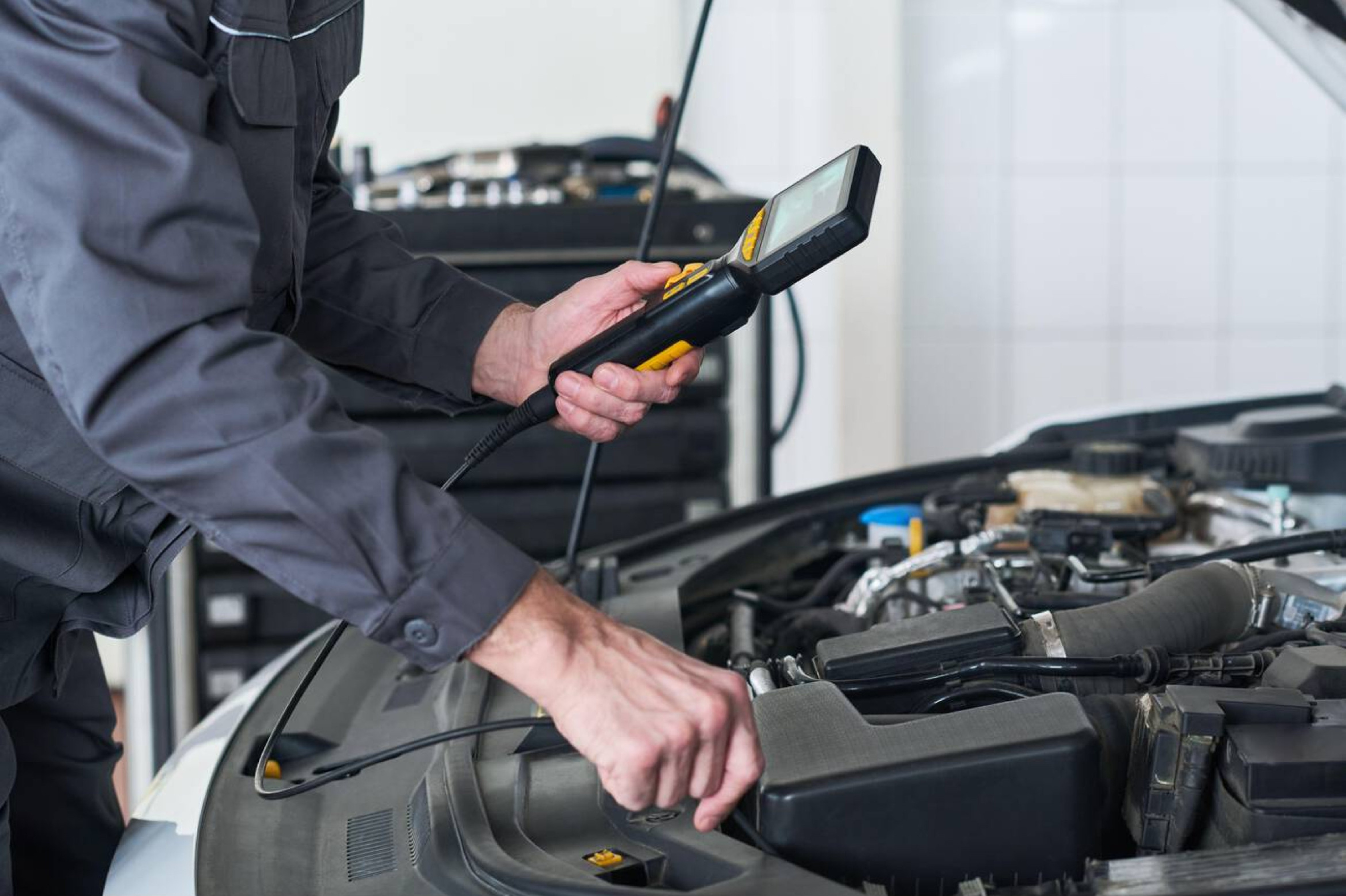 Mechanic scanning a car with a diagnostic tool